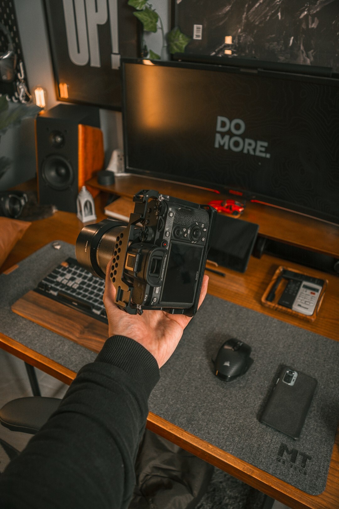 Photographer editing documentary photographs at a desk with camera gear