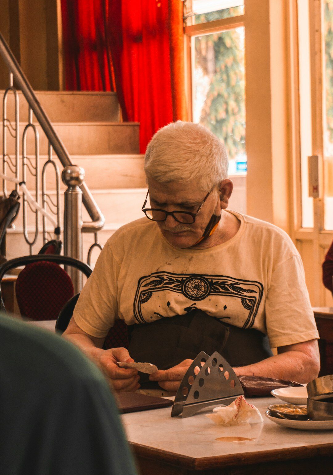 Photographer reviewing contact sheets and prints on a light table