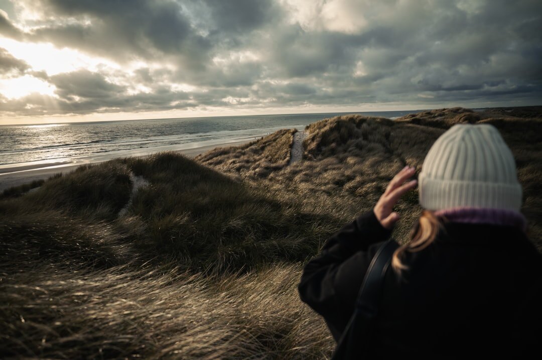 Portrait of a Danish female documentary photographer holding a camera